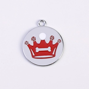 Macro detail of crown shaped pet ID tag with red enamel and bone cutout on steel