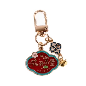Traditional Chinese style keychain with golden ingot and red cloud charm for prosperity