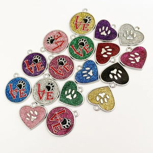 Glittering heart and round pet ID tags featuring paw prints and LOVE engraving details