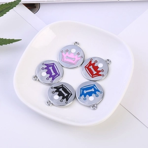 Set of five colorful crown and bone engraved pet ID tags on a white display plate