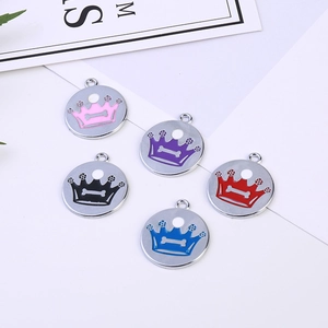 Detail showing five colorful crown pet ID tags with bone emblems on metal pendants