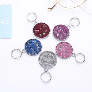 Set of five glittery round pet ID tags in red, purple, blue, pink, and silver finishes