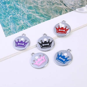 Macro shot of colorful enamel crown pet tags in purple, black, red, pink, and blue