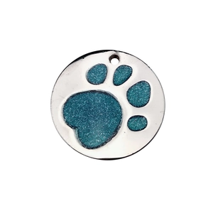 Detail of round pet tag with blue glitter paw print design in polished silver metal