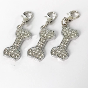 Three sparkling bone-shaped dog tags with crystal rhinestones and silver lobster clasps