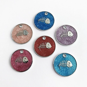 Detailed view of fishbone glitter pet ID tags in blue, gold, purple, and red colors