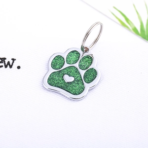 Glitter green paw-shaped pet ID tag with heart detail and silver metal ring