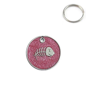 Close-up of circular pink glitter pet tag featuring a metallic silver fishbone emblem