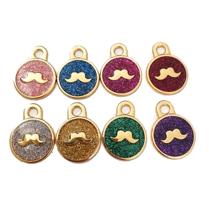 Detailed set of eight glitter mustache pet tags in various vibrant colors and gold finish