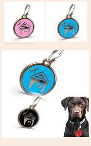 Macro detail of dog house shaped pet ID tags in pink blue black and red zinc alloy