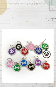 Close-up of circular metal pet ID tags with paw and bone designs in various enamel colors