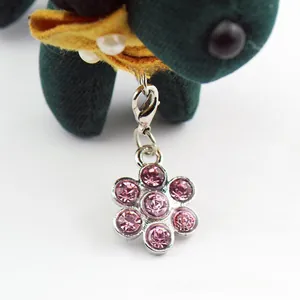 Macro shot of a pink rhinestone flower pet pendant with silver lobster claw clasp