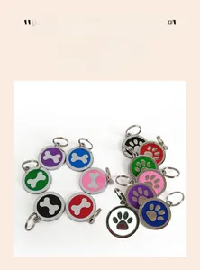 Detail of round pet ID tags with colorful bone and paw print patterns for collars