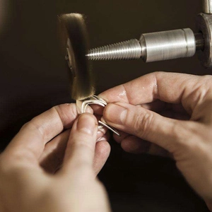 Macro shot of polishing process on multi-layer streamlined silver metal ring