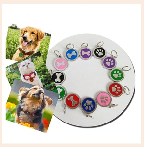 Variety of colorful round pet ID tags with paw and bone designs displayed on white background