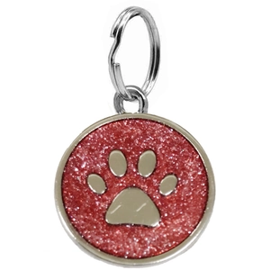 Detailed view of a round red glitter pet ID tag with a silver paw print and metal ring