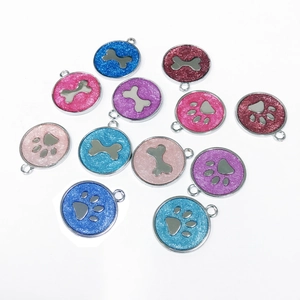 Detailed view of colorful glitter bone and paw print pet ID tags with hanging rings