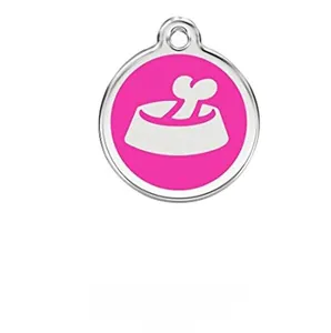 Macro detail of a round silver metal pet ID tag with a pink enamel dog bowl design