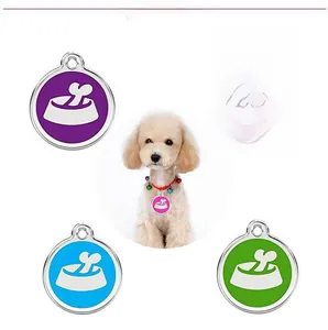 Detailed view of colorful round metal pet ID tags with bone and bowl illustrations