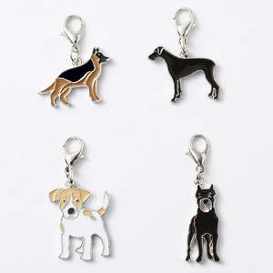 Detailed view of four enamel dog charms featuring German Shepherd and Great Dane designs