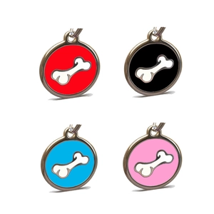 Detail showing set of four round metal pet ID tags in red black blue and pink finishes