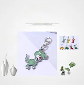 Macro detail of colorful enamel dinosaur charms with durable silver metal lobster clasps