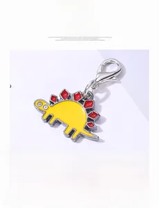 Detail of yellow and red zinc alloy dinosaur keychain with a metal lobster clasp