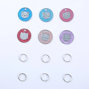 Detail of glitter pet ID tags in six colors with cat head relief and metal rings