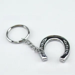 Detailed close-up of a silver polished metal horseshoe keychain with a sturdy link chain