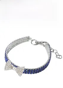 Detail of pet collar with three rows of blue rhinestones and a white crystal bow