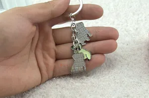 Gedetailleerd zicht op een mopshond emaille sleutelhanger met kleur en zilveren achterkant