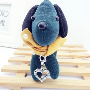 Detailed view of dog fabric charm with pearl yellow collar and crystal heart pendant