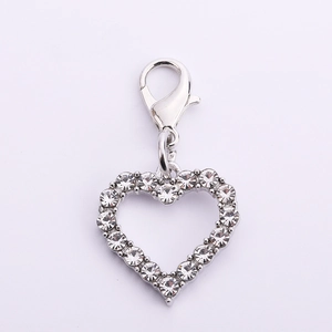 Detailed macro view of heart-shaped pet collar pendant with lobster clasp and rhinestones