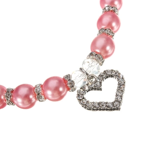 Detail of pink pearl pet necklace featuring a crystal heart pendant and rhinestone spacers
