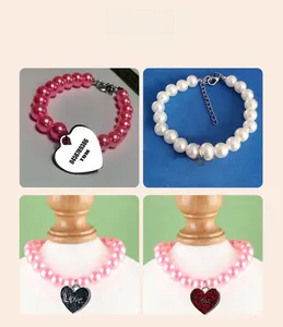 Detail view of pink and white pearl pet collar with personalized engraved heart pendant
