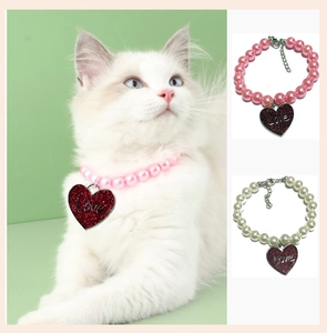Detail of pet pearl collar with heart pendant and adjustable metal chain extension