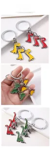 Detail of colorful enamel dinosaur keychain set with red yellow and green charms