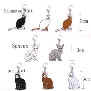 Detailed macro view of 3cm enamel cat pendants featuring Siamese and Sphynx breeds