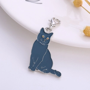 Detailed close-up of blue enamel cat pendant charm with silver lobster clasp and yellow eyes