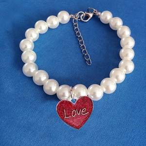 Elegant white pearl pet necklace featuring a red glitter heart pendant with Love engraving