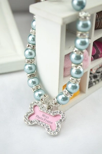 Detail of blue pearl pet necklace with bone shaped rhinestone photo frame pendant