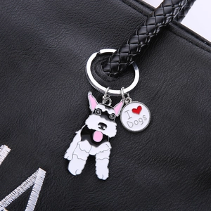Metal Schnauzer dog keychain with I Love Dogs tag on a black leather handbag strap