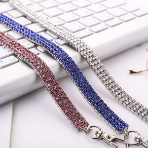 Detail view of multi-row rhinestone necklaces in pink, blue, and silver with lobster clasps