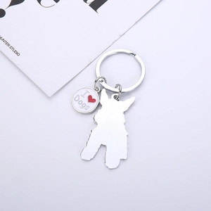Close-up of silver metal Schnauzer keychain with I Heart Dogs charm on white background