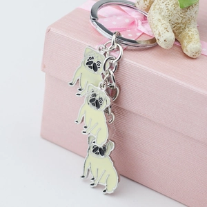 Three-link pug dog breed zinc alloy keychain charms on a pink gift box edge