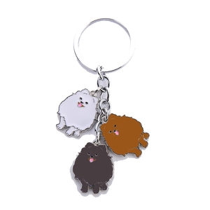 Metal Pomeranian dog keychains in white, brown, and black colors for car accessories