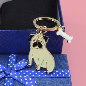 Creative pug dog keychain with small bone charm on a premium blue gift box display