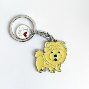 Close-up of yellow Chow Chow charm with I Love Dogs metal tag on silver keychain