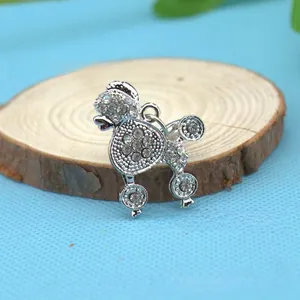 Macro view of silver-plated poodle pendant with white rhinestones on wooden base