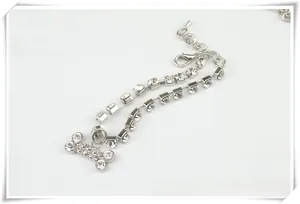 Detail of double-row rhinestone pet collar with shiny bone pendant and adjustable lobster clasp